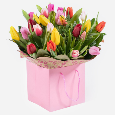 Tulip Temptations - A cheerful tulip posy hand-tied featuring a variety of beautiful colours carefully selected by the local florist. Hand-delivered in a gift bag or box.